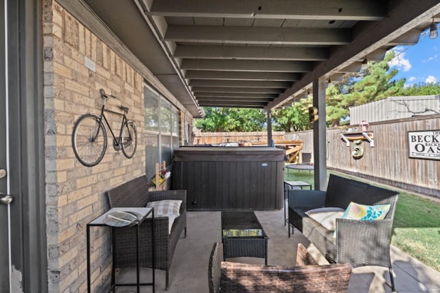 view of patio / terrace with a hot tub and an outdoor hangout area