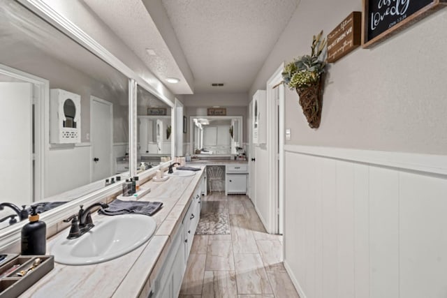 bathroom featuring vanity and a textured ceiling