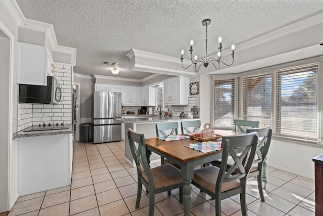 tiled dining space featuring crown molding, a chandelier, sink, and a textured ceiling