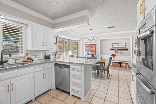 kitchen featuring sink, dishwasher, white cabinetry, ornamental molding, and kitchen peninsula