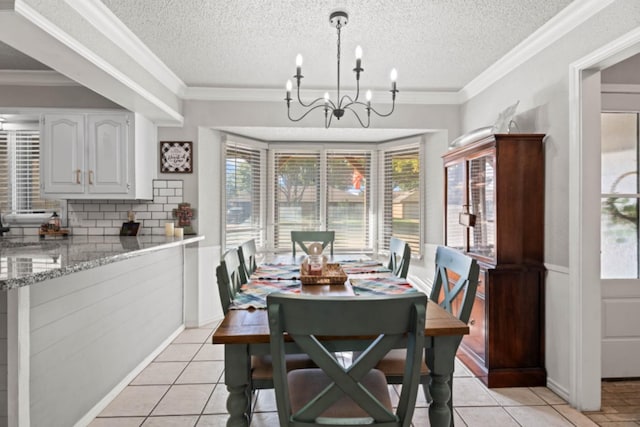 tiled dining area featuring crown molding, an inviting chandelier, a textured ceiling, and a wealth of natural light