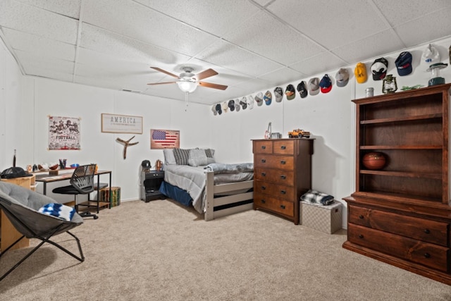 carpeted bedroom featuring a paneled ceiling and ceiling fan