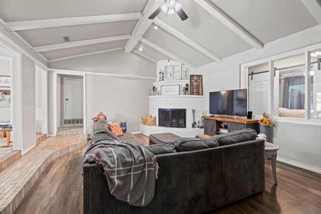 living room featuring ceiling fan, a fireplace, dark hardwood / wood-style flooring, and lofted ceiling with beams