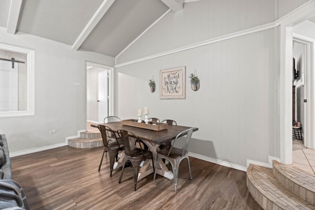 dining room with dark hardwood / wood-style floors and lofted ceiling with beams