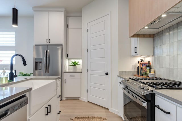 kitchen with pendant lighting, white cabinetry, and appliances with stainless steel finishes