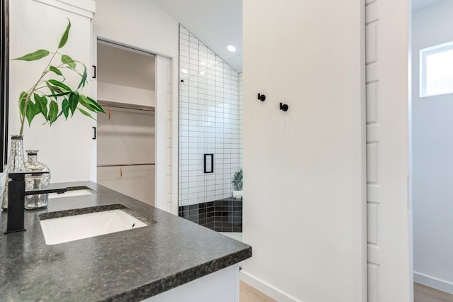 bathroom with an enclosed shower and vanity