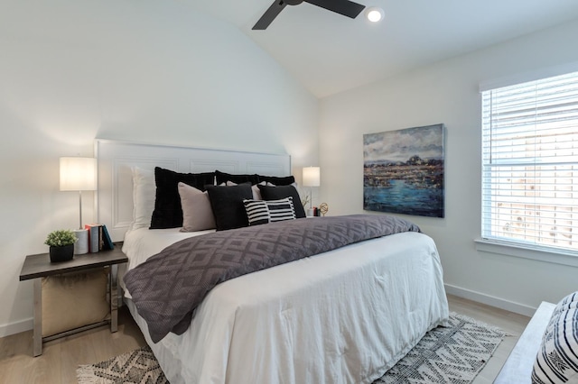 bedroom featuring vaulted ceiling, light hardwood / wood-style floors, and ceiling fan