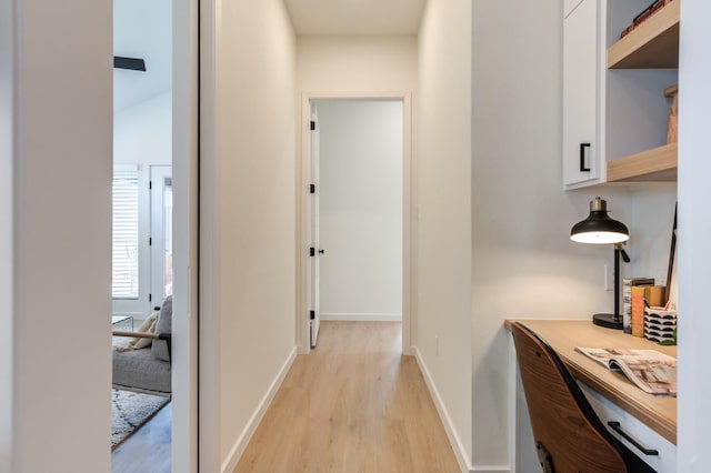 hallway with light hardwood / wood-style floors