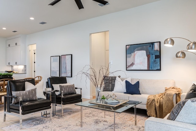 living room with ceiling fan and light hardwood / wood-style floors