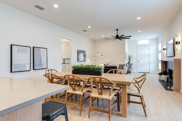 dining room with ceiling fan and light hardwood / wood-style floors