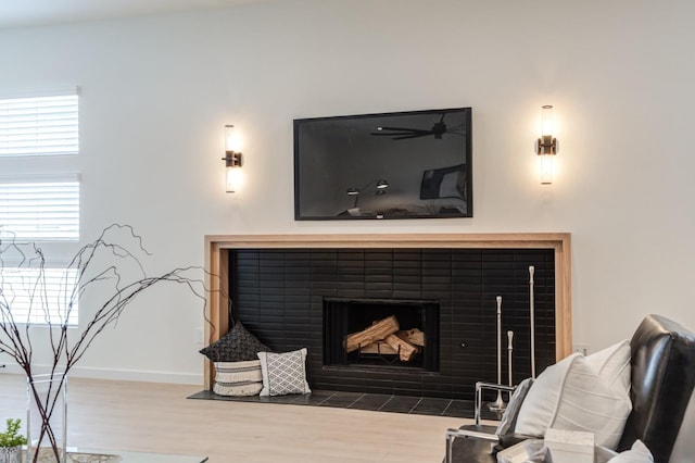 interior space featuring a tiled fireplace and light hardwood / wood-style flooring