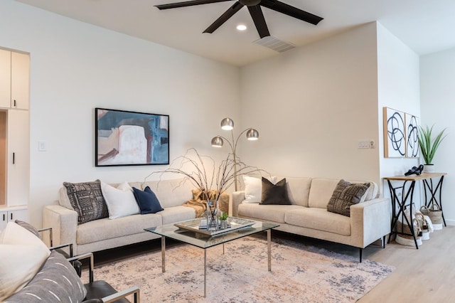 living room featuring ceiling fan and light wood-type flooring