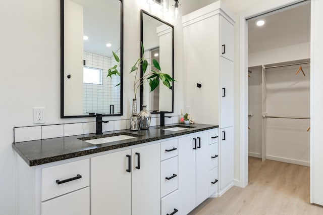 bathroom with vanity and wood-type flooring