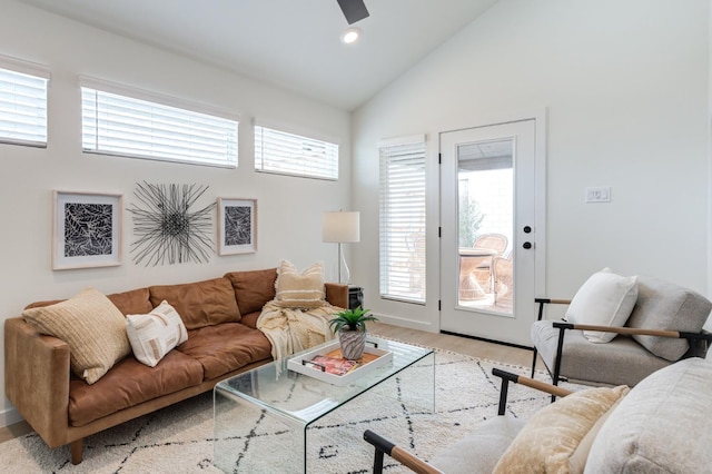 living room featuring high vaulted ceiling and light hardwood / wood-style flooring