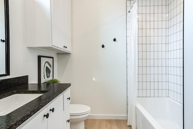 full bathroom with vanity, wood-type flooring, toilet, and shower / bath combo with shower curtain