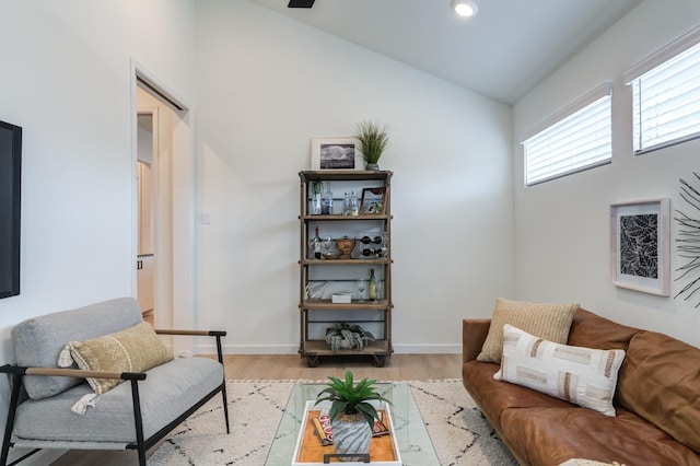 living room with vaulted ceiling and light hardwood / wood-style flooring