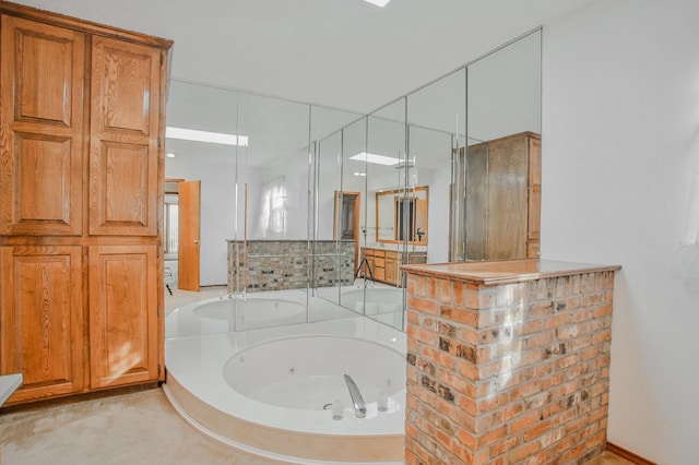 bathroom with a relaxing tiled tub