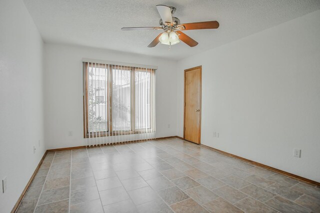 spare room with ceiling fan and a textured ceiling