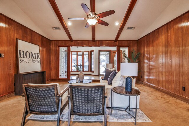 spare room with a textured ceiling, light colored carpet, and ceiling fan