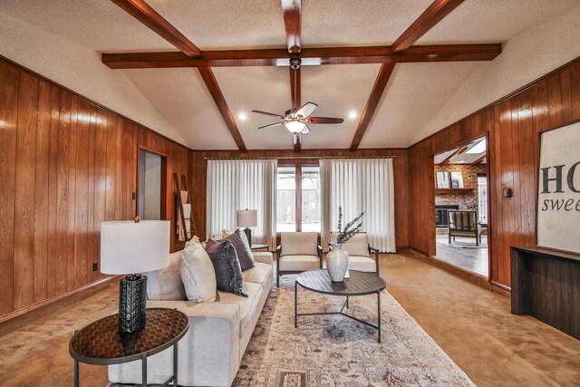 empty room featuring ceiling fan, light colored carpet, and a textured ceiling