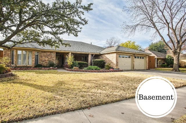 single story home featuring a garage and a front lawn