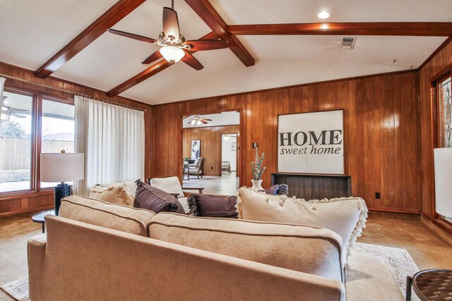 unfurnished room with ceiling fan, light carpet, and a textured ceiling