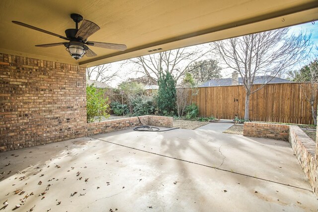 doorway to property with ceiling fan and a patio area