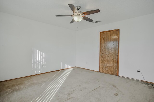 spare room featuring ceiling fan, a textured ceiling, and wood walls