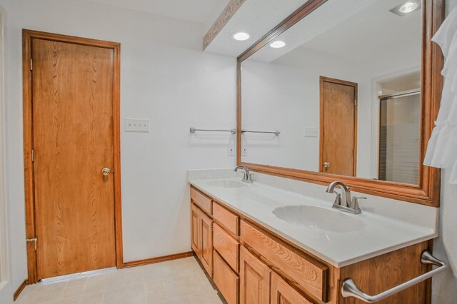 bathroom featuring vanity and an enclosed shower