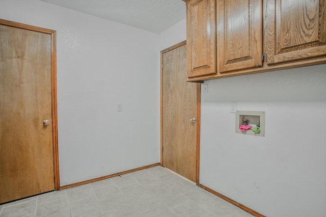 laundry room with hookup for a washing machine and cabinets