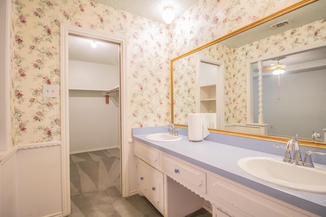 5720 71st St, Lubbock, TX 79424 - bathroom featuring double vanity and a walk in closet