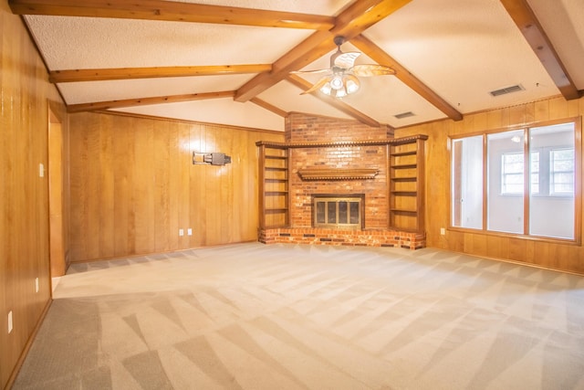 5720 71st St, Lubbock, TX 79424 - unfurnished living room featuring wood walls, carpet floors, a brick fireplace, and ceiling fan