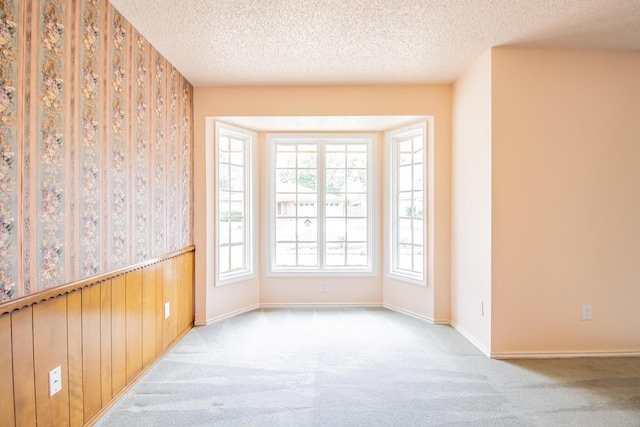5720 71st St, Lubbock, TX 79424 - carpeted spare room featuring a textured ceiling and wallpapered walls