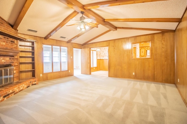 5720 71st St, Lubbock, TX 79424 - unfurnished living room with wooden walls, a ceiling fan, carpet floors, and a brick fireplace