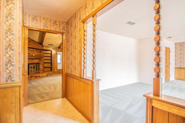 5720 71st St, Lubbock, TX 79424 - corridor featuring light colored carpet, wallpapered walls, and a textured ceiling