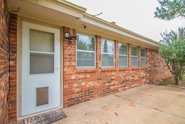 5720 71st St, Lubbock, TX 79424 - property entrance featuring brick siding and a patio area