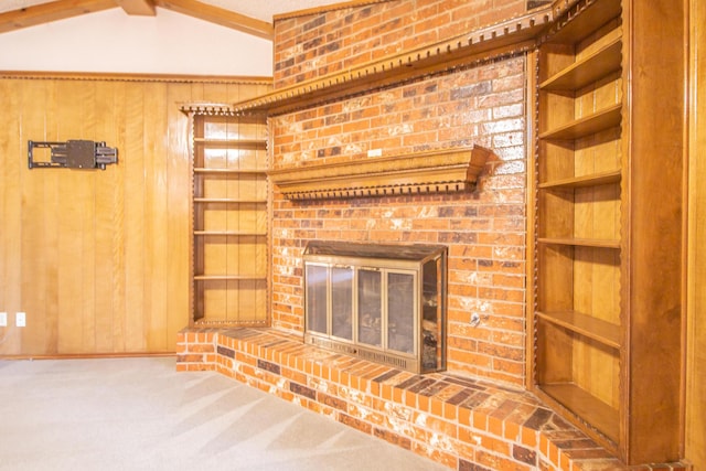 5720 71st St, Lubbock, TX 79424 - unfurnished living room with wood walls, carpet floors, and a fireplace