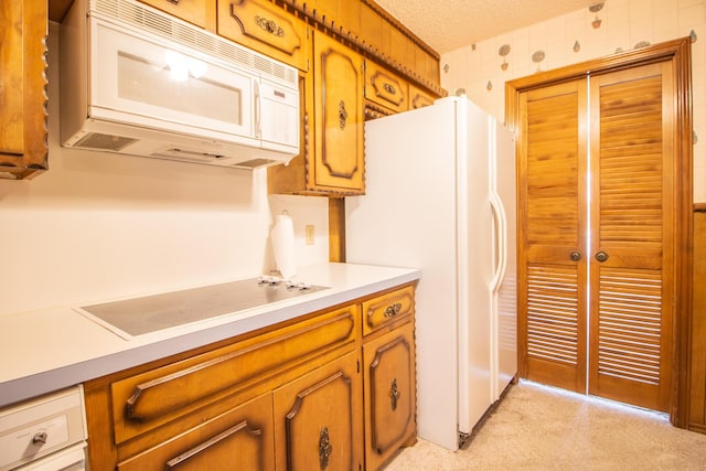 5720 71st St, Lubbock, TX 79424 - kitchen with white appliances, light colored carpet, light countertops, brown cabinetry, and a textured ceiling