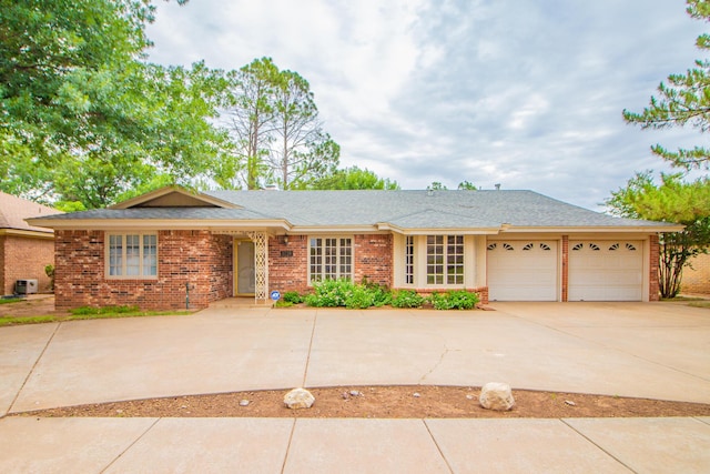 5720 71st St, Lubbock, TX 79424 - ranch-style home with brick siding, an attached garage, concrete driveway, and roof with shingles