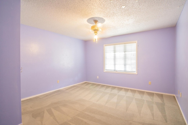 5720 71st St, Lubbock, TX 79424 - spare room with light colored carpet, a textured ceiling, and a ceiling fan