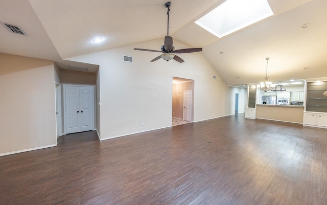 unfurnished living room featuring ceiling fan with notable chandelier, dark wood finished floors, and visible vents