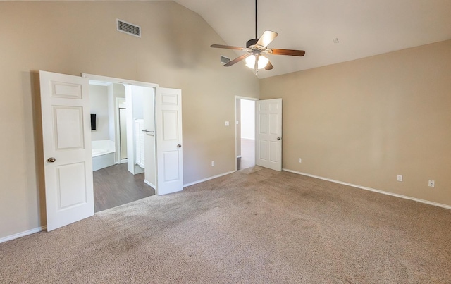 unfurnished bedroom with high vaulted ceiling, carpet flooring, visible vents, and baseboards