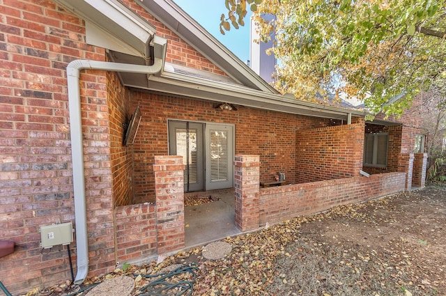 entrance to property featuring brick siding