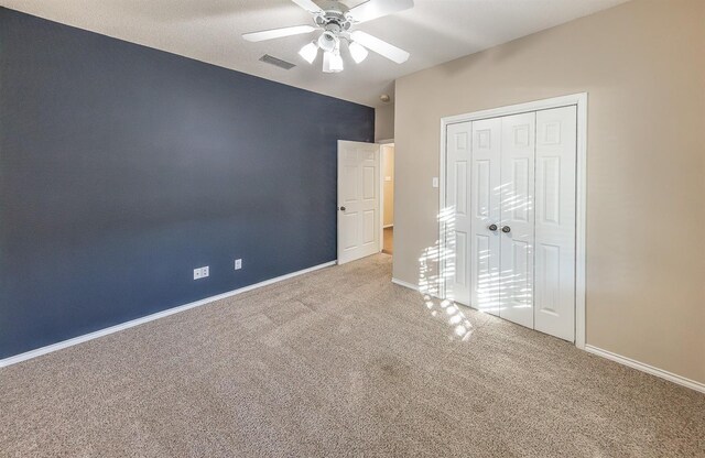 unfurnished bedroom featuring a closet, carpet, visible vents, and baseboards