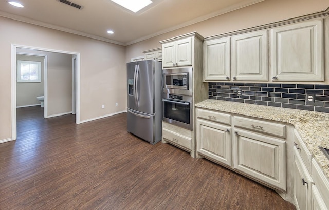 kitchen featuring crown molding, light stone counters, stainless steel appliances, and decorative backsplash