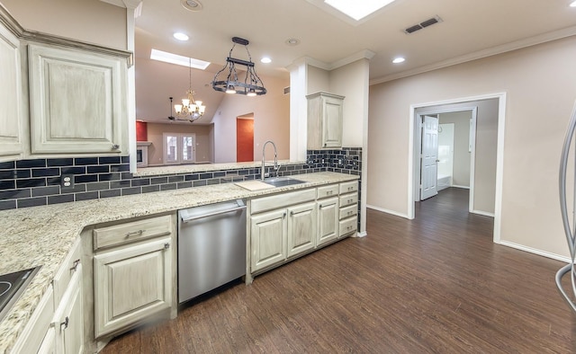 kitchen with visible vents, dishwasher, dark wood-style floors, cream cabinets, and a sink