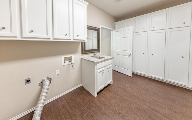 laundry area featuring dark wood finished floors, hookup for a washing machine, cabinet space, hookup for an electric dryer, and a sink