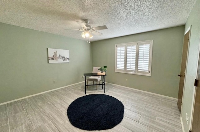 sitting room featuring ceiling fan and a textured ceiling