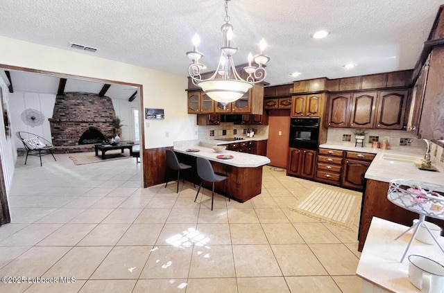 7907 Knoxville Ave, Lubbock, TX 79423 - kitchen featuring black appliances, a sink, a peninsula, light countertops, and tasteful backsplash