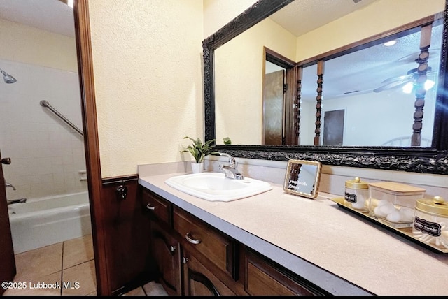 7907 Knoxville Ave, Lubbock, TX 79423 - full bath with vanity, shower / washtub combination, tile patterned floors, wainscoting, and a textured wall